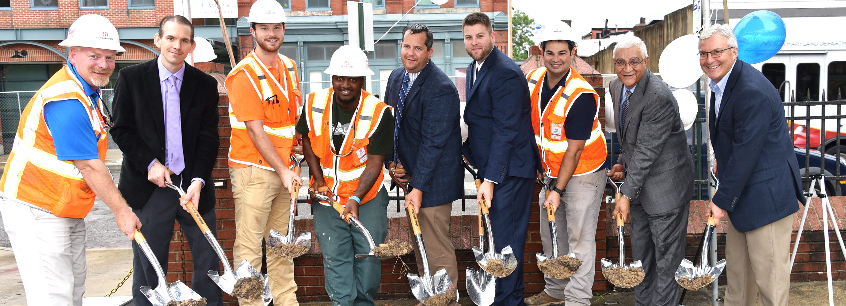 Side by side with shovels in hand for Paca House Renovation project groundbreaking