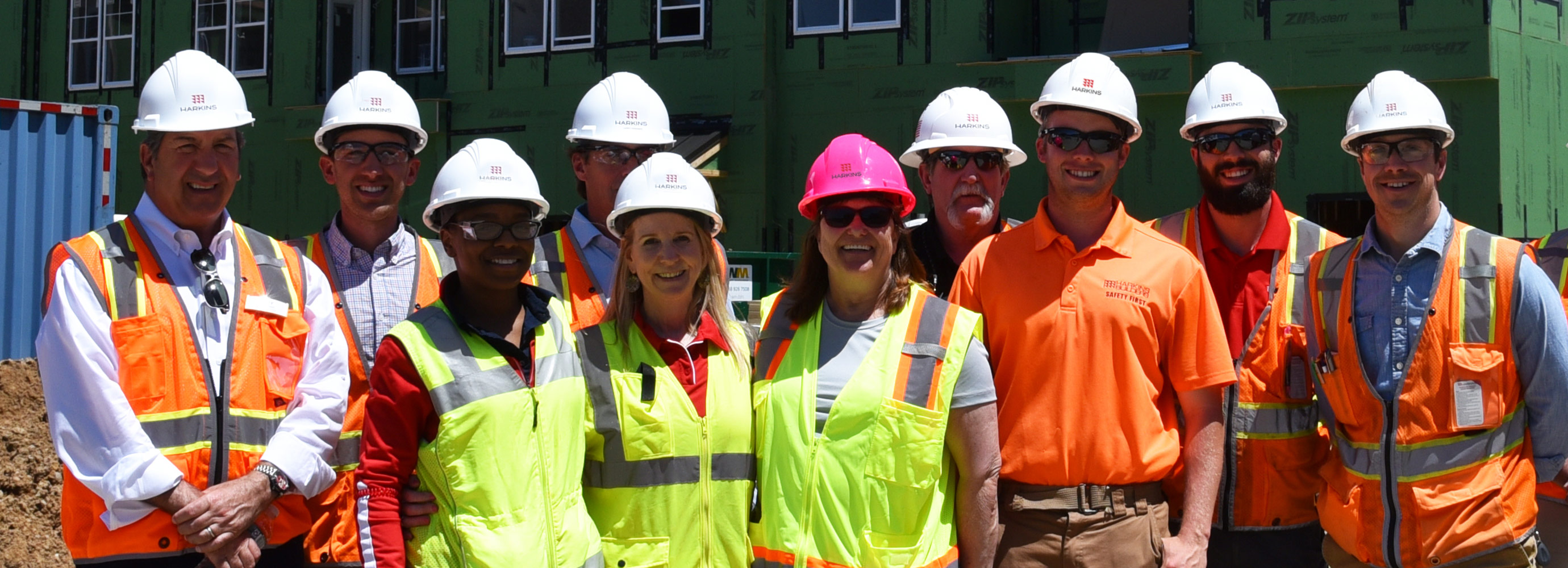 Smiling faces and construction hats on site at Community Parc