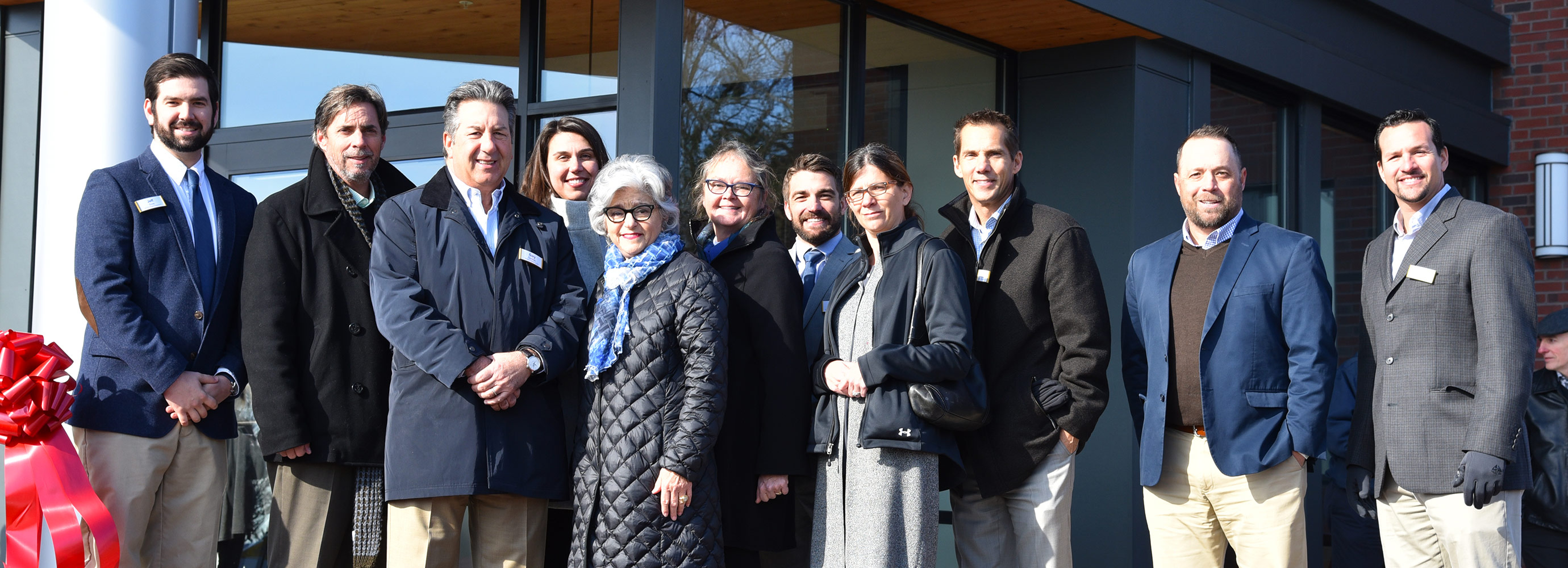 Metro Heights Grand Opening group in front of building