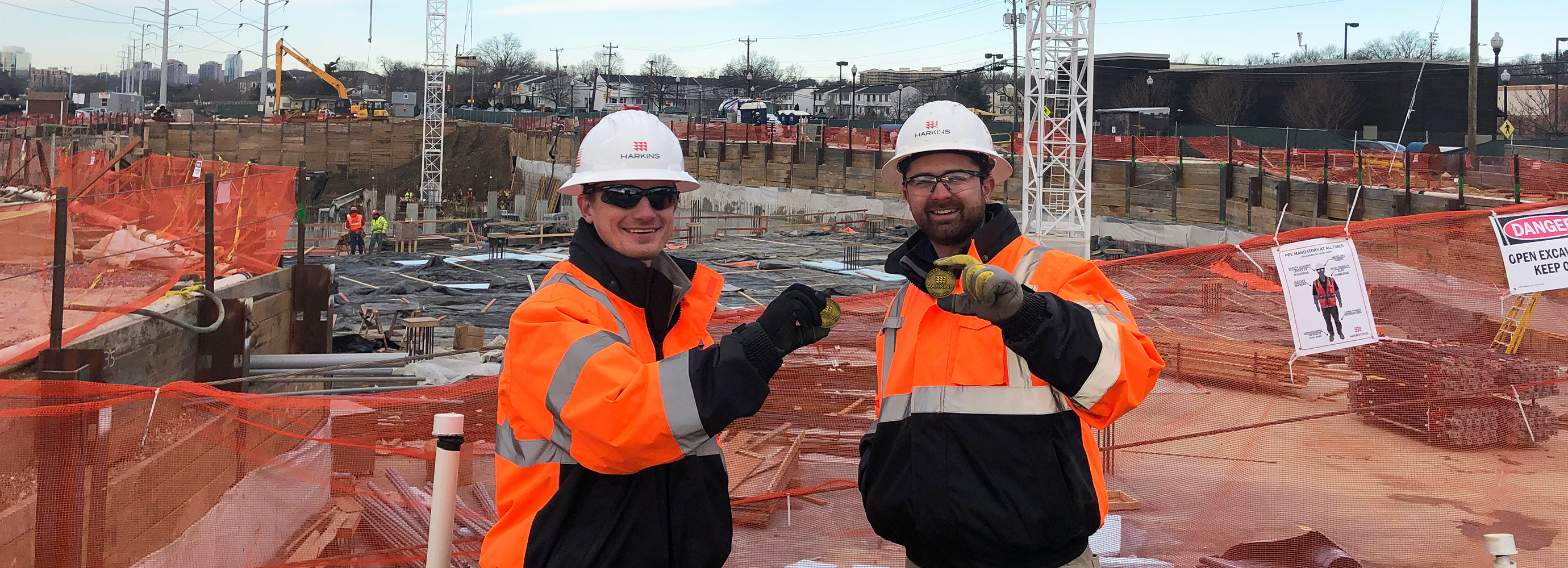 construction workers on jobsite holding safety coins