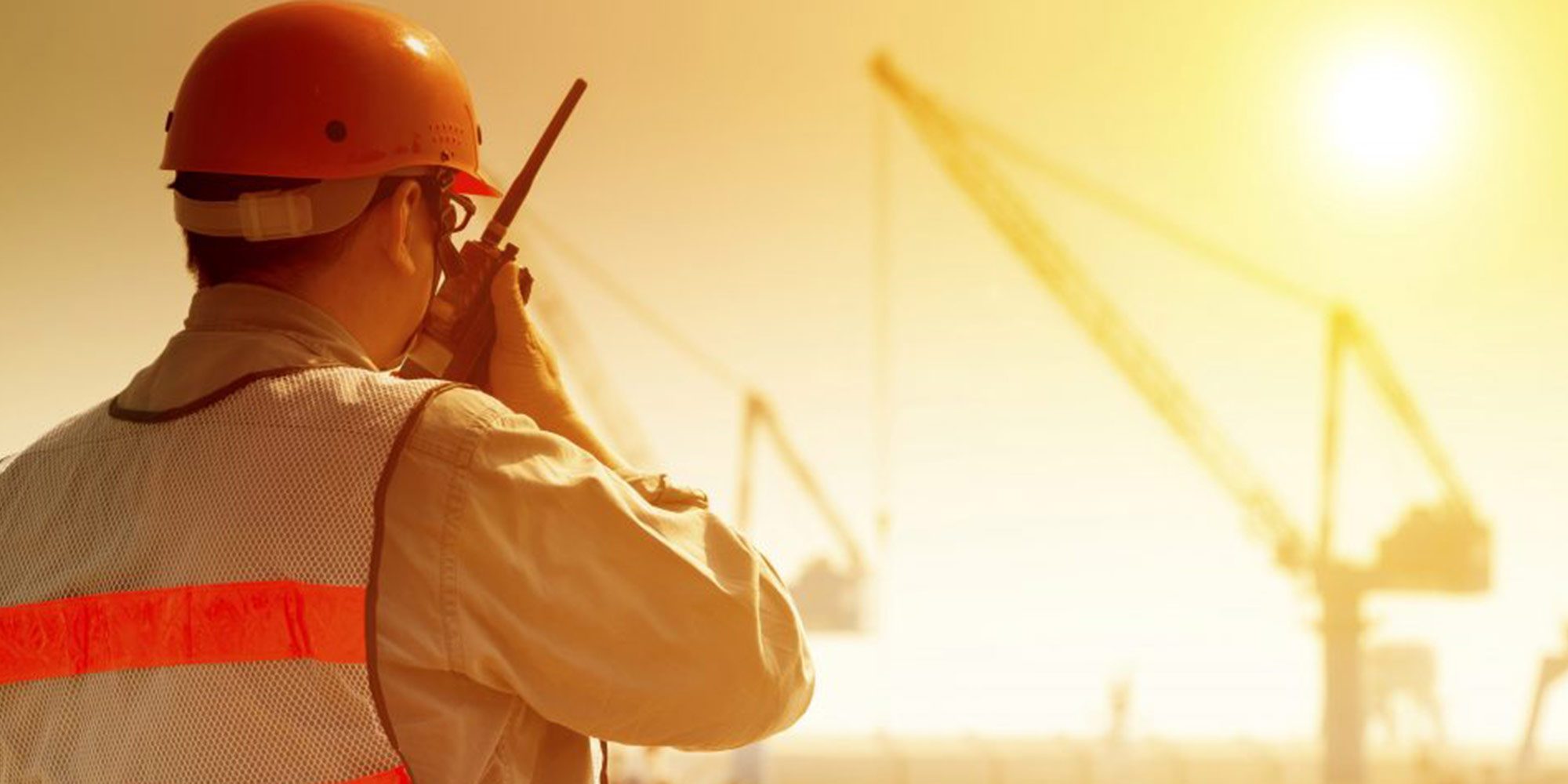 Construction worker monitors team for high-heat exposure