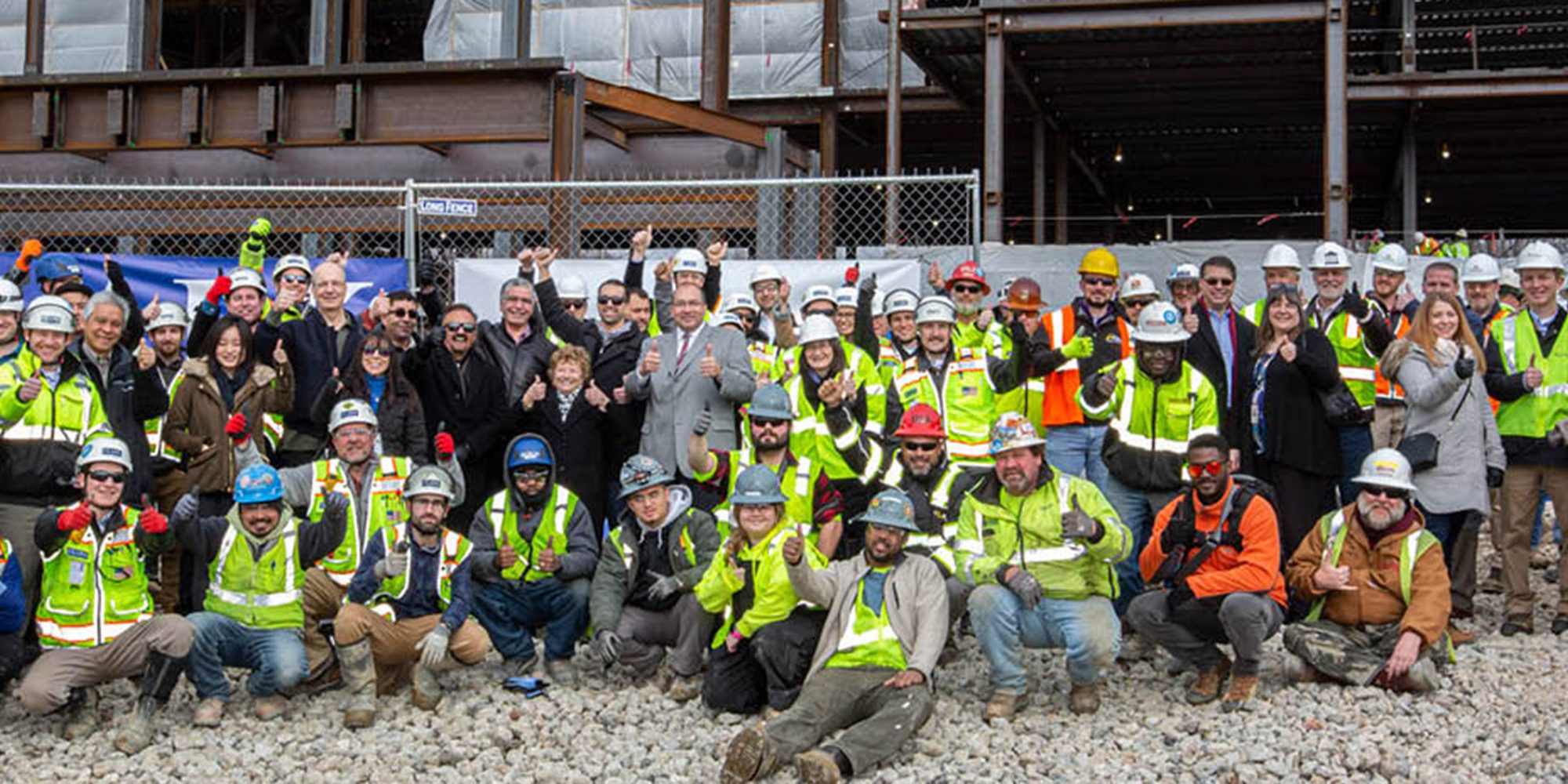 Clark Construction, Harkins, and trades gather to celebrate topping out of courthouse building