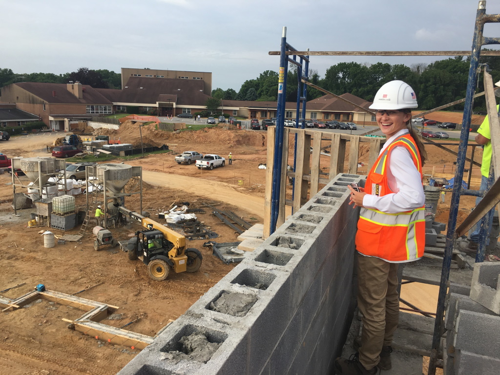 Construction worker building cinder block wall