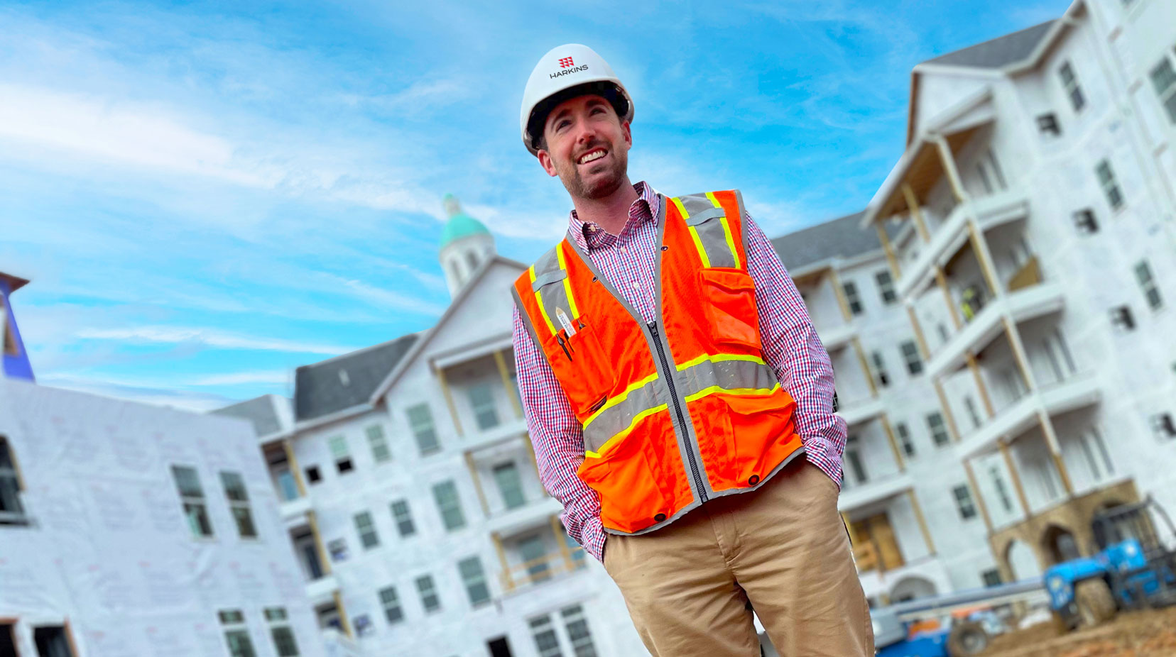 Construction worker standing in front of a building