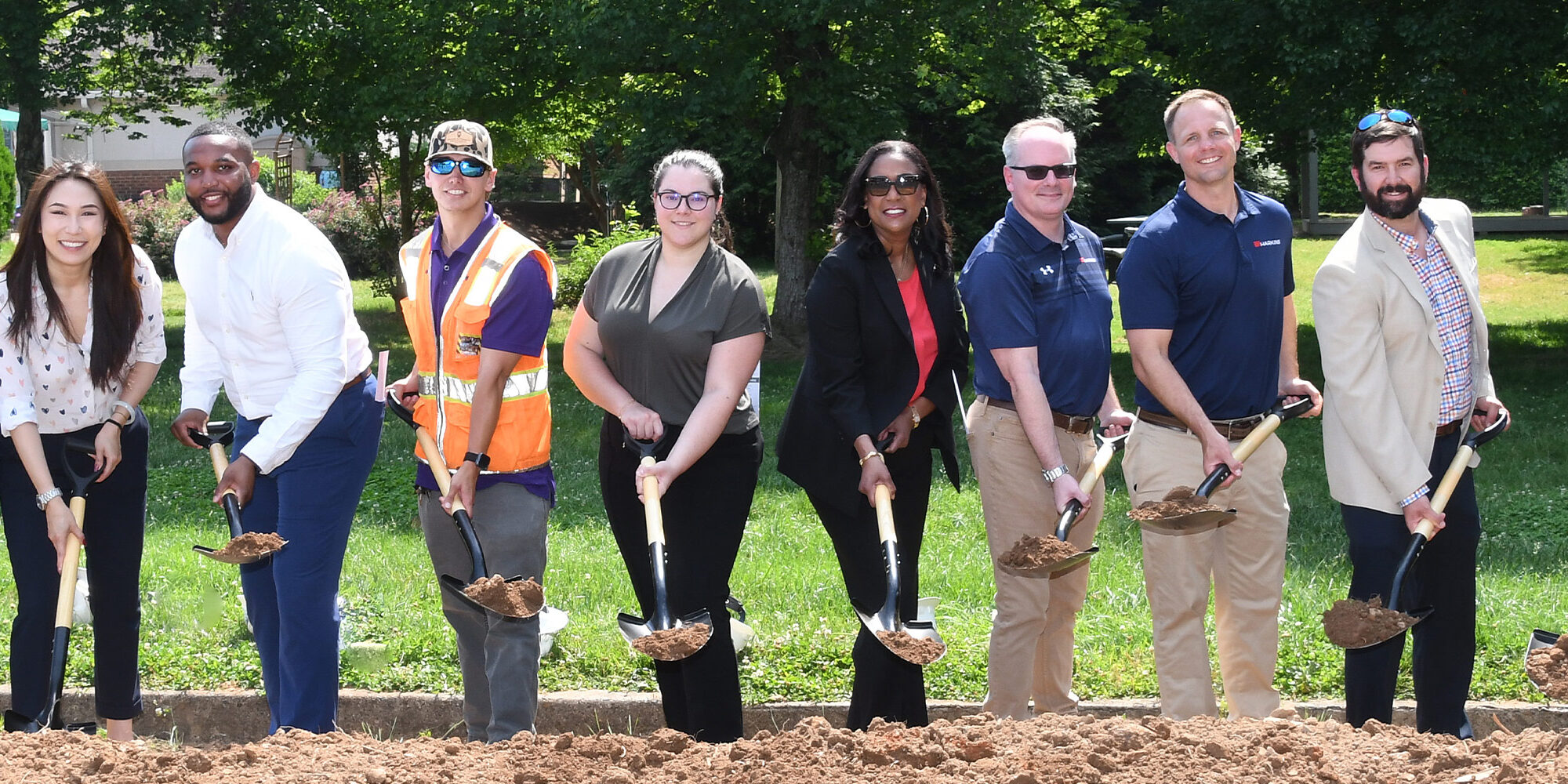 group photo holding shovels